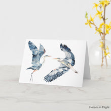 Load image into Gallery viewer, Greeting card featuring print of watercolor painting by contemporary artist Elizabeth Becker. Blank inside for any occasion. Flying herons. Expressive birds in flight. Minimalist modern wildlife animals. Dark blue, gray, peach and white colors.  Loose, expressive, minimalist, modern watercolor art.