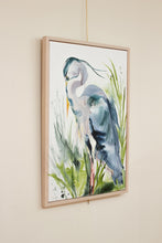 Load image into Gallery viewer, 24” x 36" original watercolor painting on canvas in 26" x 38" natural maple solid wood floater frame. Large-scale expressive Great Blue Heron water bird standing in marsh or lake. Expressive, impressionist, loose, watery, flowing, painterly, abstract, minimalist, modern, moody style by contemporary fine artist Elizabeth Becker. Monochromatic olive green, dark blue and white colors.