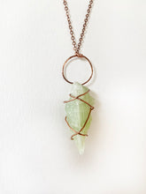 Load image into Gallery viewer, Pale Light Lime Green Calcite Wire-Wrapped Copper Pendant Necklace. Genuine Real Raw Crystal Gemstone Sourced in Asheville, North Carolina. Minimalist Modern Bohemian Style with Criss-Cross X Design. Authentic One-of-a-Kind Handmade Jewelry.
