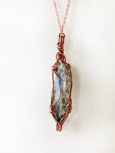 Load image into Gallery viewer, Blue Kyanite Wire-Wrapped Copper Pendant Necklace. Genuine Real Raw Crystal Gemstone Sourced in Asheville, North Carolina. Minimalist Modern Bohemian Style with Criss-Cross Design. Authentic One-of-a-Kind Handmade Jewelry.
