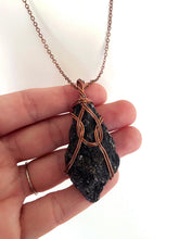 Load image into Gallery viewer, Black Pyroxenite Wire-Wrapped Antique Copper Pendant Necklace. Genuine Real Raw Crystal Gemstone. Foraged Rock Found on a Hike near Asheville in Western North Carolina. Minimalist Modern Bohemian Style with Circle Design. Authentic One-of-a-Kind Handmade Jewelry.
