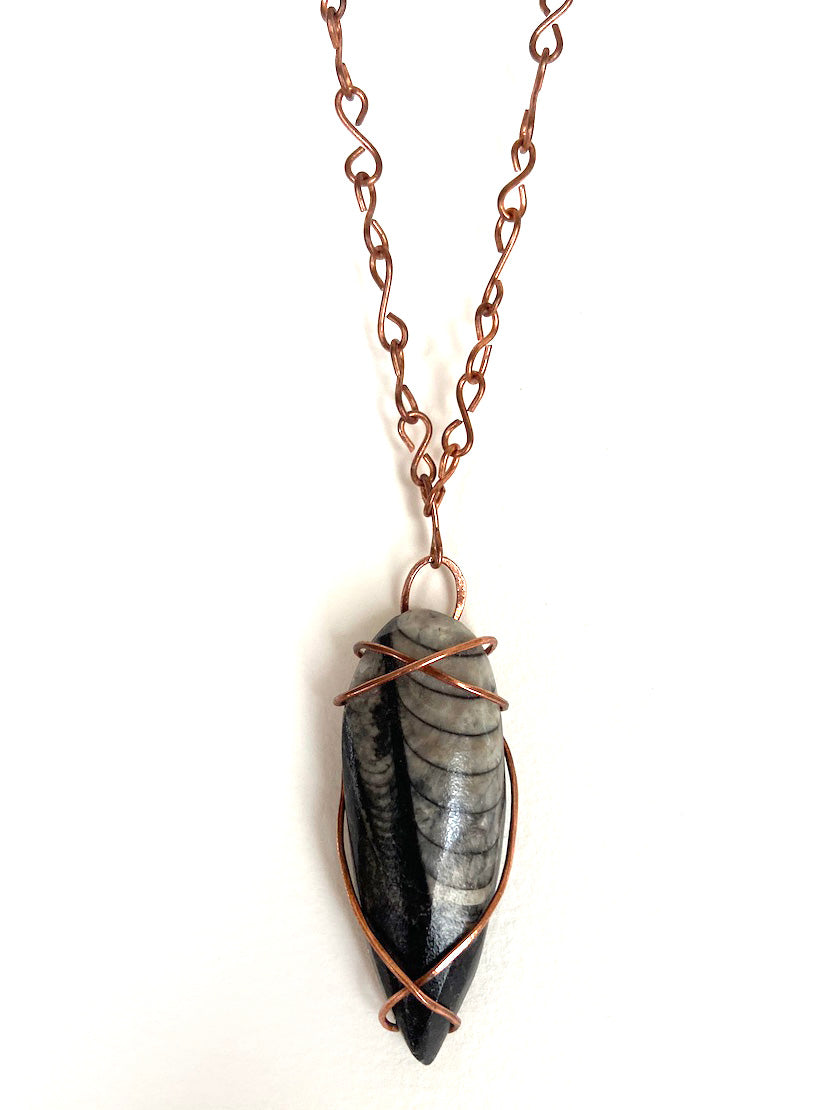 Ancient Orthoceras Fossial & Wire-Wrapped Antique Copper Pendant Necklace. Genuine Real Oblong Black Gemstone Sourced in Asheville, North Carolina. Minimalist Modern Bohemian Style Design. Authentic One-of-a-Kind Handmade Jewelry.
