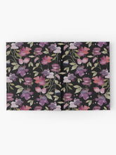 Load image into Gallery viewer, Hardcover journal featuring original hand-painted watercolor painting by artist Elizabeth Becker. Ruled line, graph or blank pages. Purple, pink, red and pale green on black background. Abstract floral. Flowers and leaves.
