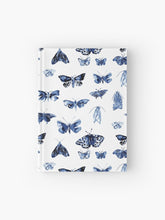 Load image into Gallery viewer, Hardcover journal featuring original hand-painted watercolor painting by artist Elizabeth Becker. Ruled line, graph or blank pages. Blue and white colors. Vintage moth or butterfly pattern. Insects design. 
