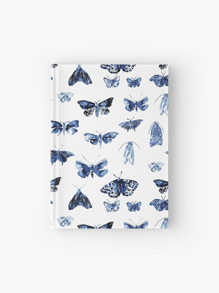 Hardcover journal featuring original hand-painted watercolor painting by artist Elizabeth Becker. Ruled line, graph or blank pages. Blue and white colors. Vintage moth or butterfly pattern. Insects design. 